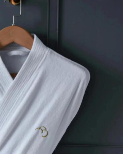 a white shirt with a pair of handcuffs on a hanger at Hotel Kapok Shenzhen HouHai (Close to Shenzhen Bay) in Shenzhen