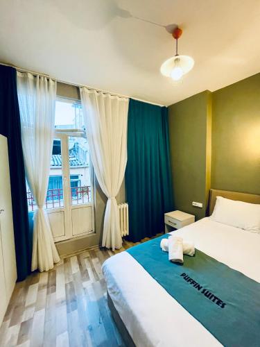 a bedroom with a bed and a large window at Puffin Boutique - Istanbul in Istanbul