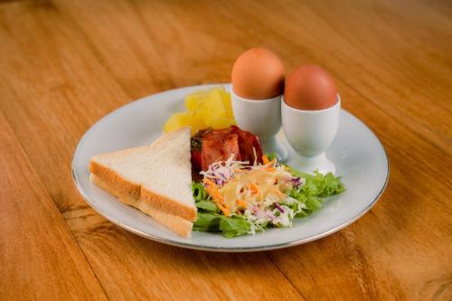 a plate of food with eggs and a salad at Kubu Sakian Villa and Restaurant Sidemen in Silebeng