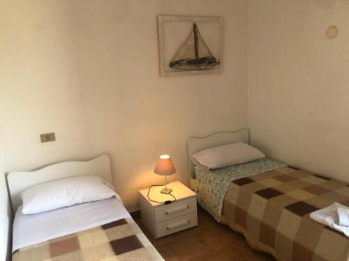 Ένα ή περισσότερα κρεβάτια σε δωμάτιο στο Hotel Porto Puddu - Il Nido dei Gabbiani