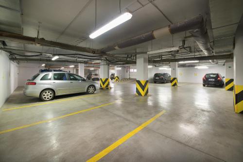 a parking garage with several cars parked in it at Hotel Grand Litava Beroun in Beroun