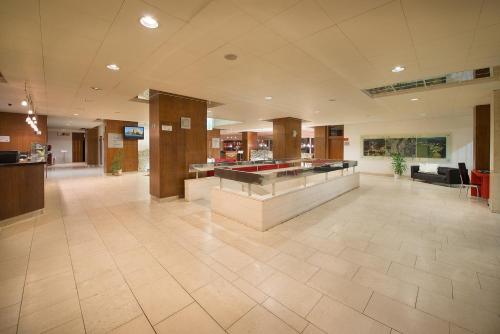 a lobby of a hospital with a check in counter at Hotel Grand Litava Beroun in Beroun