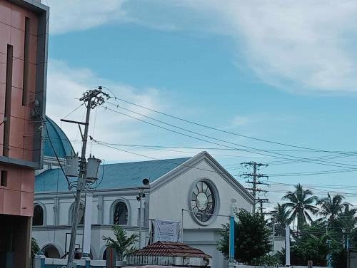 a church with a clock on the front of it at QUICKSHIELD HOMESTAY in Naga