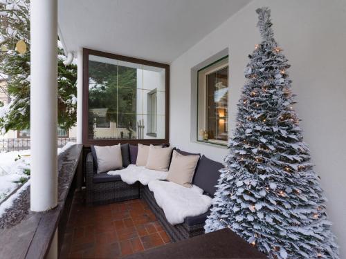 a living room with a christmas tree and a couch at MANNI Gästehaus in Mayrhofen