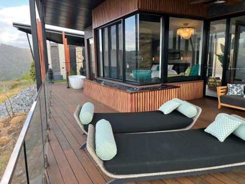 a patio with a couch and chairs on a deck at On Eagle Wings Mountain Retreat & Spa in Neranwood