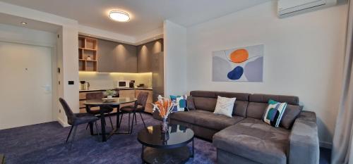 a living room with a couch and a table at Beograd na vodi - Belgrade Waterfront Riverside in Belgrade