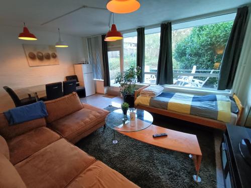 a living room with a couch and a bed at Three bedroom apartment in Heerlen in Heerlen