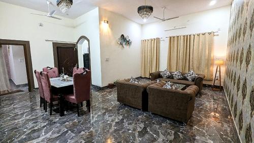 a living room with a couch and a table at Prakriti Homestay in Roorkee