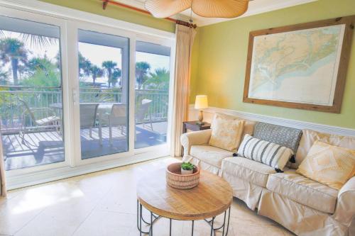 a living room with a couch and a table at Seaside Therapy~ in Seabrook Island