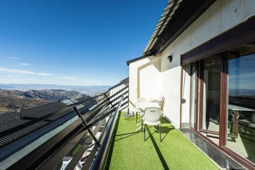 a balcony with chairs and a view of the mountains at LUZ in Sierra Nevada