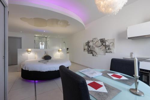 a bedroom with a bed and a table with chairs at Love Loft in Bordeaux