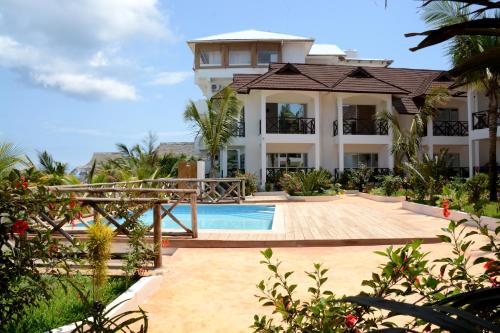 a large house with a swimming pool and a building at Sansi Kendwa Beach Resort in Kendwa