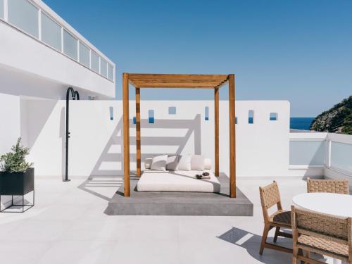a bed on the roof of a house at Mondrian Ibiza in Cala Llonga