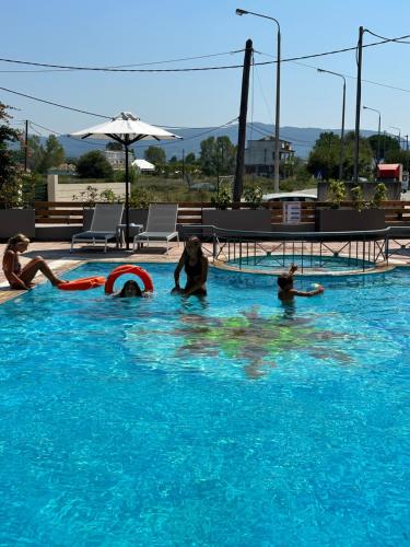 a group of people playing in a swimming pool at Harma Corfu in Sidari
