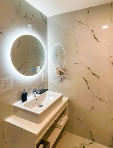 a bathroom with a sink and a mirror at DX Apartments in Berlin