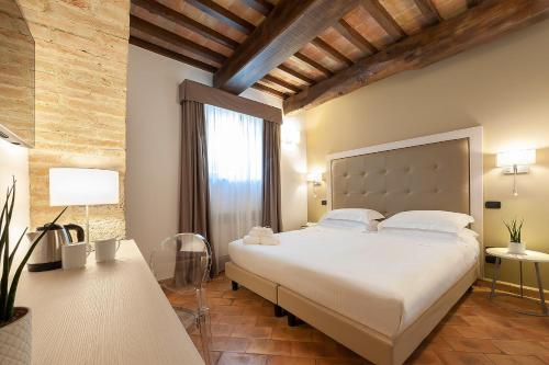 a bedroom with a large bed and a large window at Relais dell'Olmo in Perugia