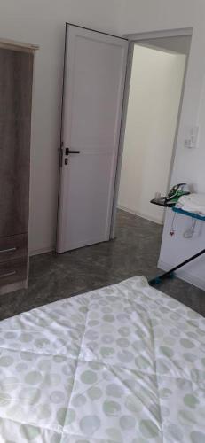 a room with two sliding doors and a bed at Villa Bella is 5 mins from the beach with amazing garden overlooking the pool in Trou dʼ Eau Douce