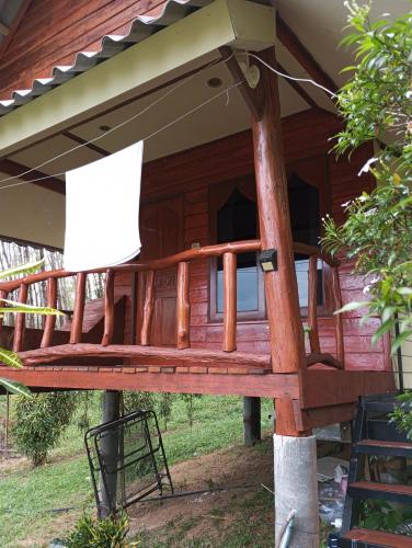 a porch of a wooden house with a sign at Mookanda bungalow in Ko Yao Noi