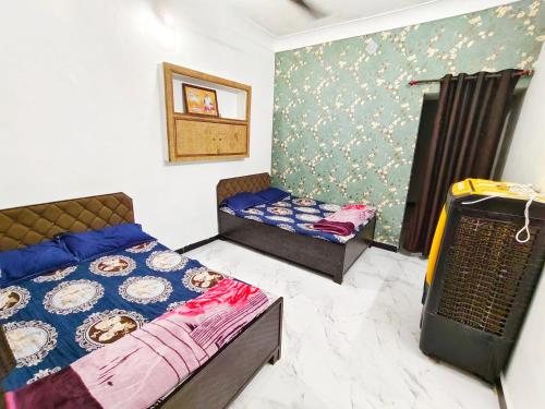 a bedroom with two beds in a room at Shivay homestay ujjain in Ujjain