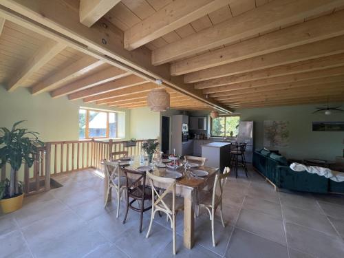 a dining room and kitchen with a table and chairs at Gîte des Pierres de Barme in Olby