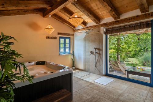een grote badkamer met een bad en een douche bij Villa Paradiso in Umag