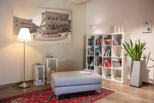 a living room with a chair and a book shelf at Relais dell'Olmo in Perugia