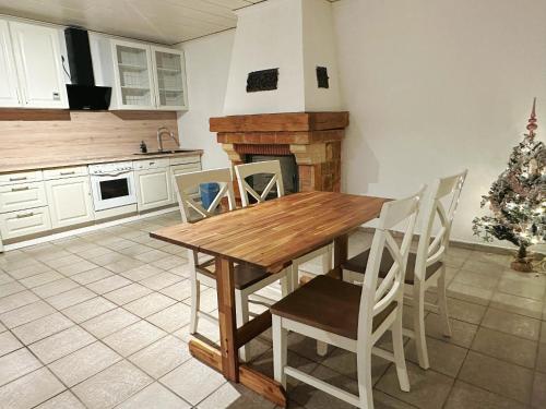 a kitchen with a table and chairs and a christmas tree at Zimmer in 100m² Wohnung mit Terrasse in Duisburg