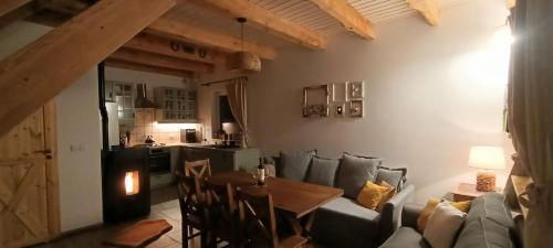 a living room with a couch and a table at Smocze Ranczo 3 in Ośno Lubuskie