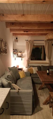 a living room with a couch and a table at Smocze Ranczo 3 in Ośno Lubuskie