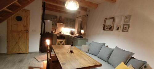 a living room with a couch and a wooden table at Smocze Ranczo 3 in Ośno Lubuskie