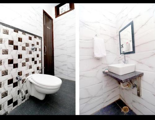 a white bathroom with a toilet and a sink at Kesari root in Amritsar