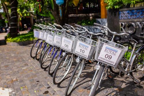 a row of bikes parked on a sidewalk at Royal Riverside Hoi An Hotel & Spa in Hoi An