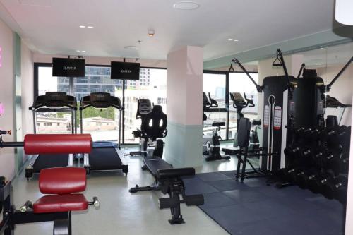 a gym with cardio equipment in a building at The Quarter Ratchathewi by UHG in Bangkok