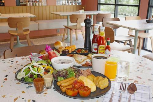 a table with two plates of food on it at The Quarter Ratchathewi by UHG in Bangkok