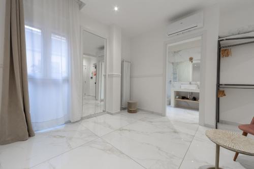 a living room with white walls and white tile floors at Leia Hospitality in Milan