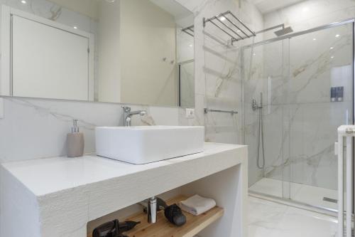 a white bathroom with a sink and a shower at Leia Hospitality in Milan