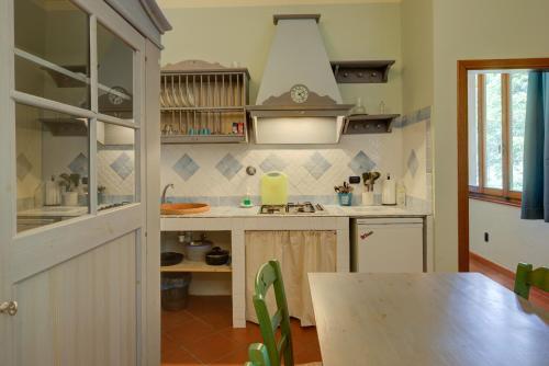 a kitchen with a counter and a table in it at Albergo Villa San Michele in Greve in Chianti