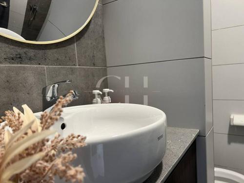 a white sink in a bathroom with a mirror at The Podium 3 bedrooms @ 8 pax Free Internet & TV Box in Kuching