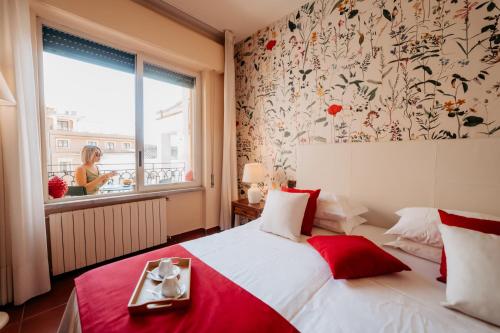 a bedroom with a red and white bed and a window at A Casitta Luxury Apartments in Taormina