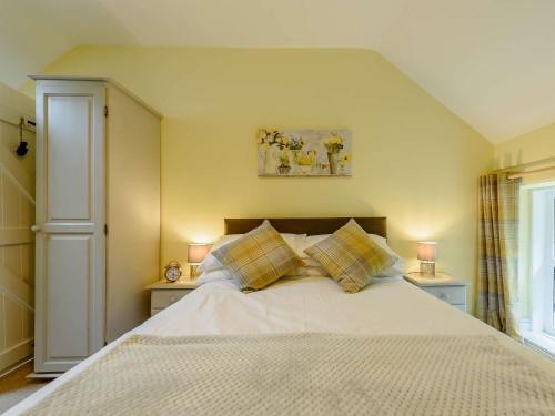 a bedroom with a large bed with two night stands at 2 bed property in Llandysul 88775 in Llanfihangel-ar-Arth