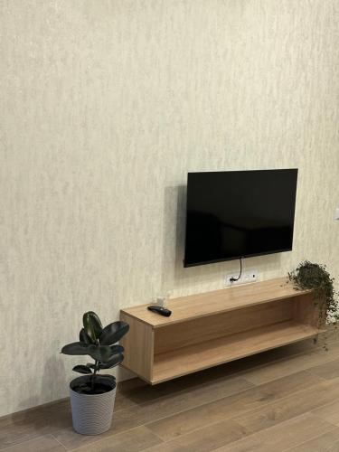 a flat screen tv sitting on top of a wooden entertainment center at The Cube in Kremenchuk