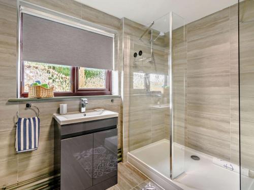 a bathroom with a sink and a glass shower at 2 Bed in Hailsham 89416 in Hailsham