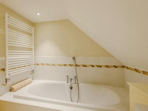 a large white bath tub in a bathroom at 4 bed in Lulworth CHRIC in West Lulworth