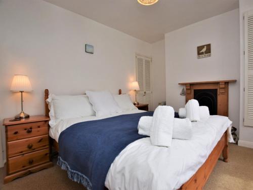 a bedroom with a large bed with white pillows at 1 Bed in Appledore MASTR in Appledore