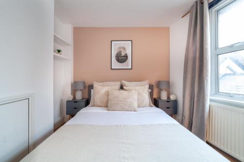 a bedroom with a large white bed and a window at The Richmond Apartments in Richmond upon Thames