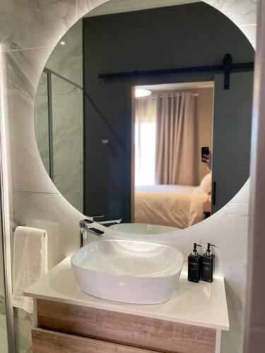 a bathroom with a sink and a mirror at Gariep Airbnb Kimberley in Kimberley