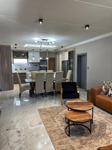 a living room with a couch and a table at Gariep Airbnb Kimberley in Kimberley