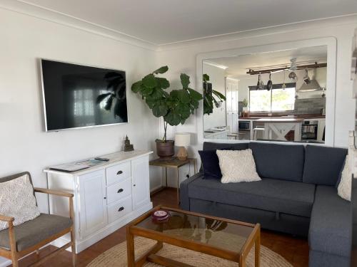 a living room with a couch and a table at Emma’s Place in Sawtell