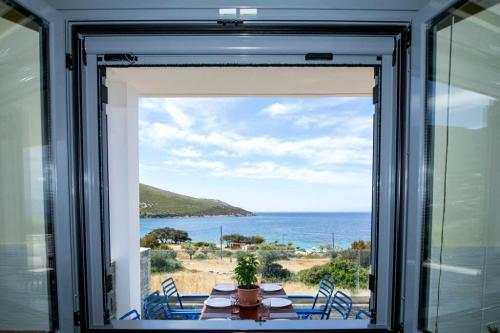 a dining room window with a view of the ocean at Seaview Villa in Nimporio in Nimporio