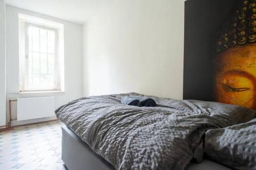 a bedroom with a bed with a blanket and a window at Work & Stay Apartment Goch in Goch